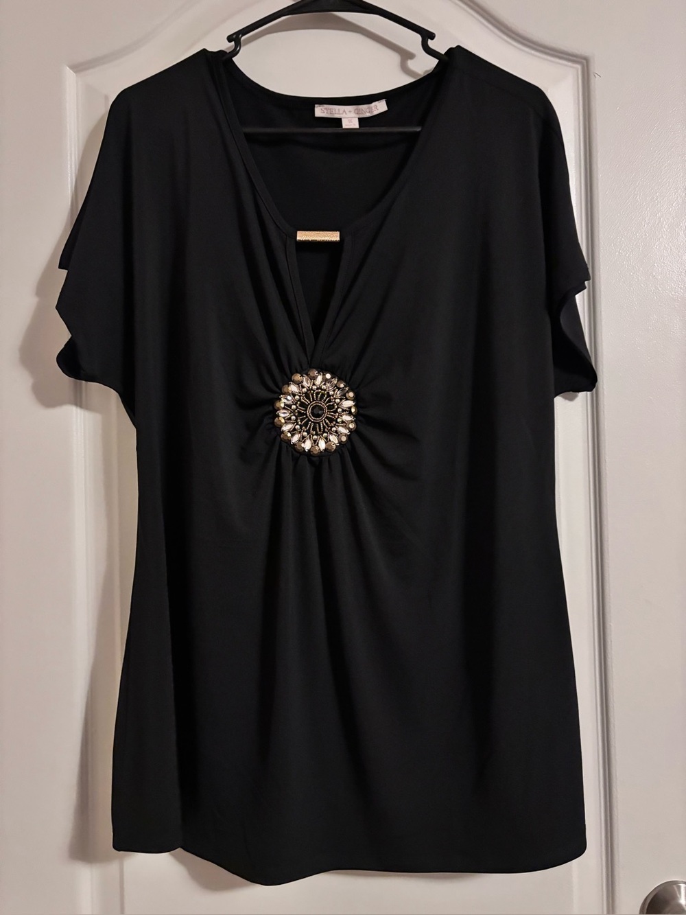 Black Women's V-Neck Blouse with Decorative Medallion
